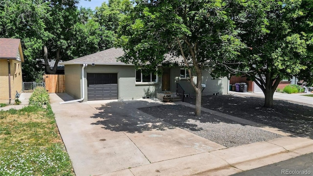 3036 Wolff St S, Denver, CO 80236 - view of front of house featuring concrete driveway, a garage, brick siding, and roof with shingles