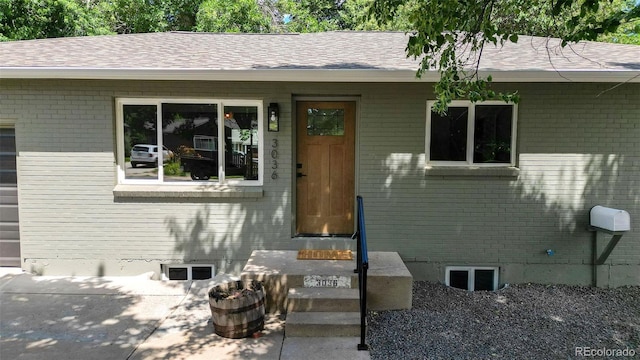 3036 Wolff St S, Denver, CO 80236 - entrance to property featuring brick siding and roof with shingles