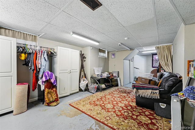 finished basement featuring a paneled ceiling