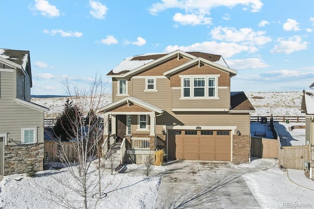 craftsman-style home with fence, driveway, and an attached garage