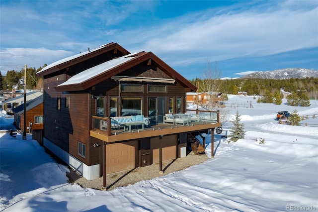 snow covered property featuring a deck