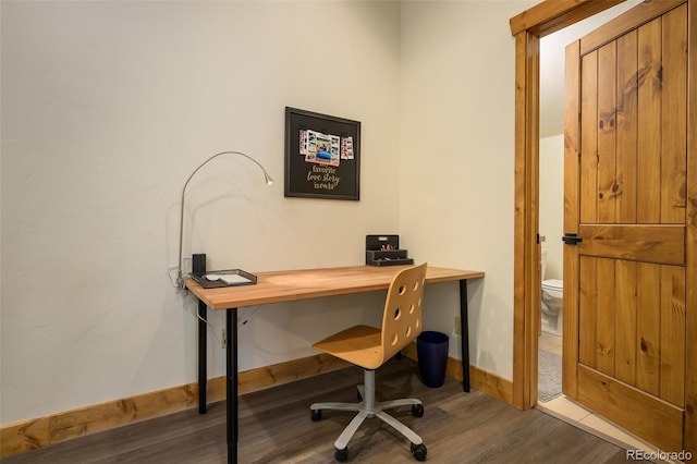 home office featuring baseboards and wood finished floors