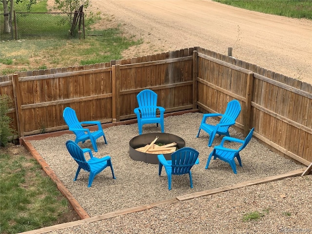 view of play area with a fire pit, a patio area, and a fenced backyard