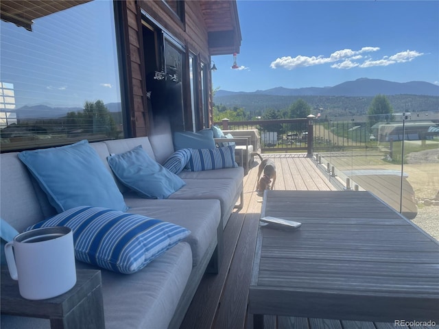 balcony featuring an outdoor living space and a mountain view