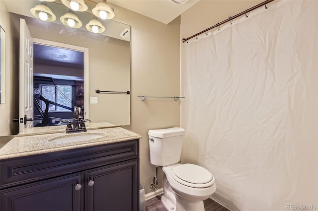 bathroom with wood-type flooring, toilet, and vanity