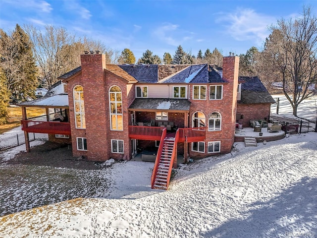 snow covered property featuring a wooden deck