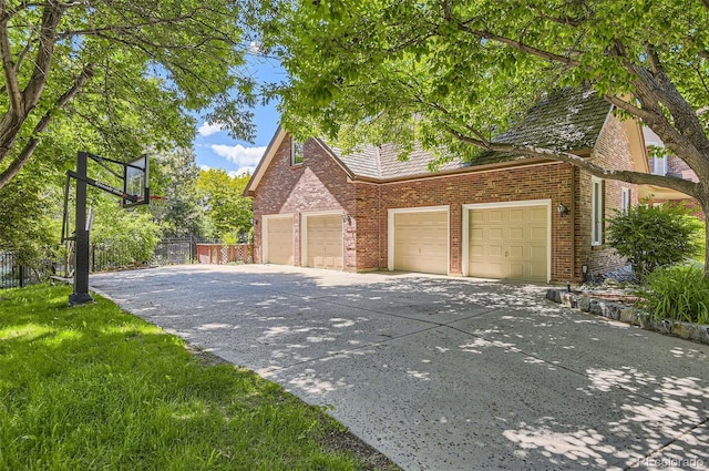 4681 S Columbine Ct, Cherry Hills Village, CO 80113 - view of side of property featuring an attached garage, concrete driveway, and brick siding