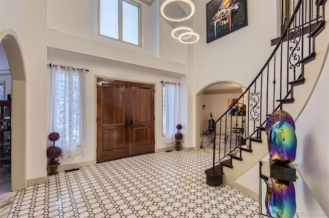4681 S Columbine Ct, Cherry Hills Village, CO 80113 - foyer featuring arched walkways, a high ceiling, and stairs
