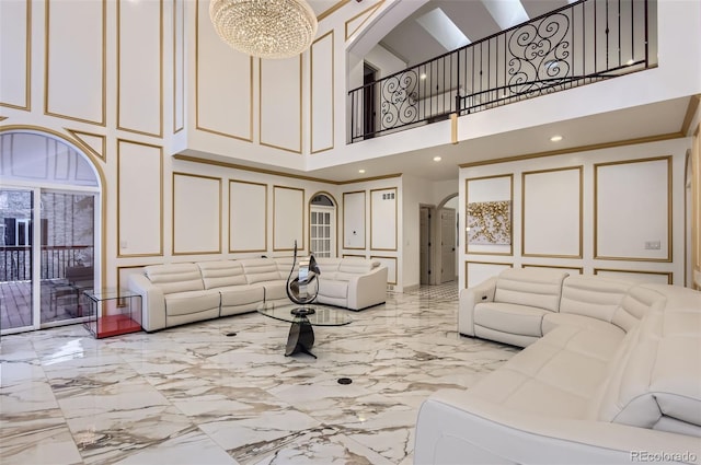 4681 S Columbine Ct, Cherry Hills Village, CO 80113 - living room with a decorative wall, a towering ceiling, marble tiled flooring, arched walkways, and a chandelier