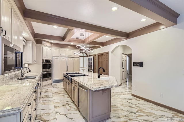 4681 S Columbine Ct, Cherry Hills Village, CO 80113 - kitchen featuring appliances with stainless steel finishes, arched walkways, beamed ceiling, light marble finish floors, and a large island