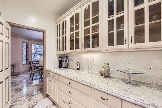 4681 S Columbine Ct, Cherry Hills Village, CO 80113 - kitchen featuring light stone countertops, light marble finish floors, glass insert cabinets, and cream cabinets