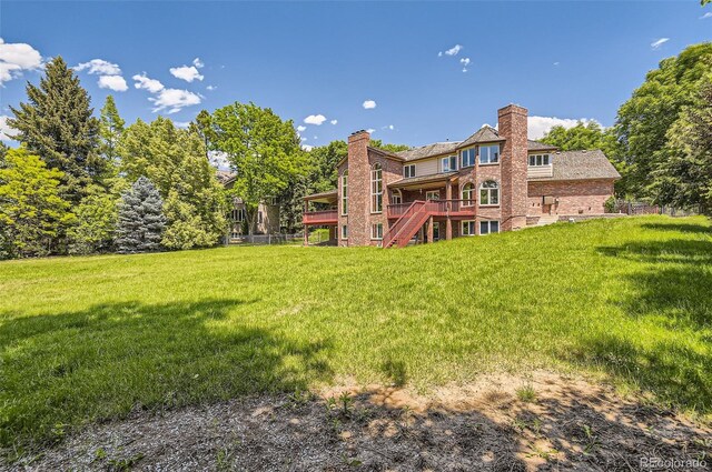 4681 S Columbine Ct, Cherry Hills Village, CO 80113 - back of house featuring stairs, a lawn, a deck, a chimney, and brick siding