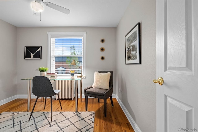 2867 Jasmine St, Denver, CO 80207 - sitting room with radiator heating unit, wood finished floors, an office area, and ceiling fan