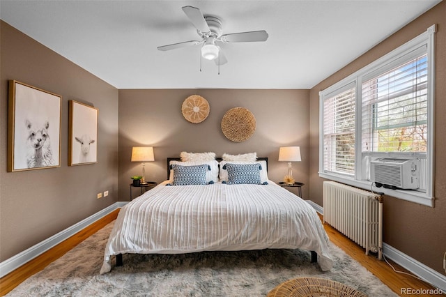 2867 Jasmine St, Denver, CO 80207 - bedroom featuring radiator heating unit, wood finished floors, cooling unit, and ceiling fan