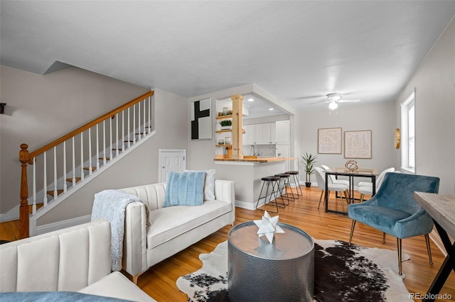 2867 Jasmine St, Denver, CO 80207 - living area featuring stairway, light wood-style flooring, and a ceiling fan