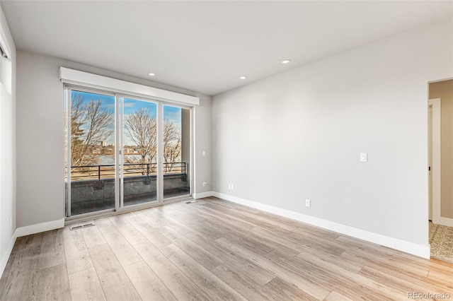 empty room with light hardwood / wood-style floors