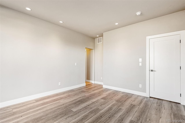 empty room with light hardwood / wood-style flooring