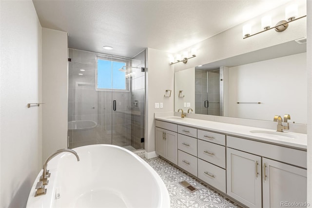 bathroom featuring vanity, shower with separate bathtub, a textured ceiling, and tile patterned floors