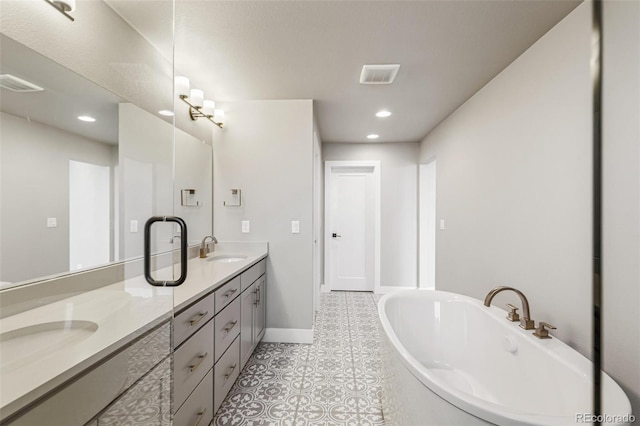 bathroom featuring a bath, vanity, and tile patterned floors