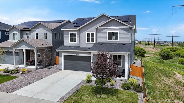 4585 High Mesa Cir, Castle Rock, CO 80108 - view of front of house featuring driveway, board and batten siding, an attached garage, and roof mounted solar panels