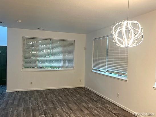 11282 Osage Cir N Unit F, Northglenn, CO 80234 - empty room featuring a chandelier, wood finished floors, and baseboards