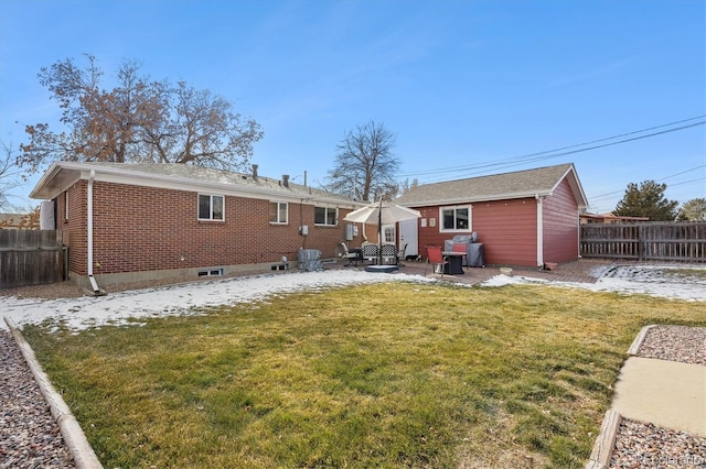 rear view of house featuring central AC, a patio area, and a lawn