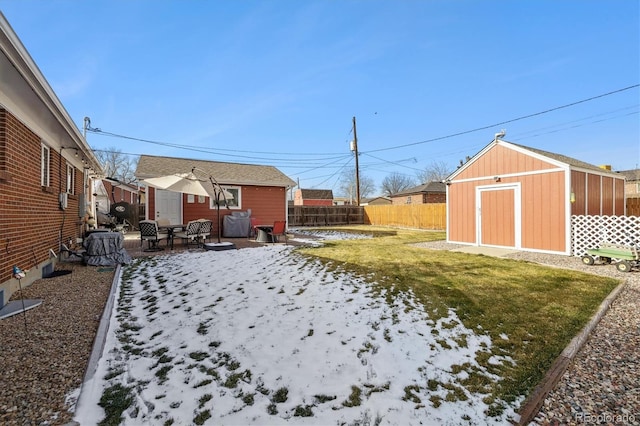 view of yard featuring a patio and a storage unit