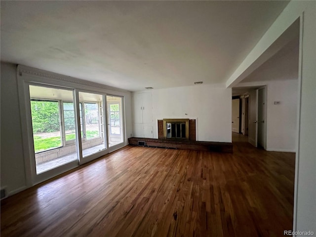 unfurnished living room with a fireplace and wood-type flooring