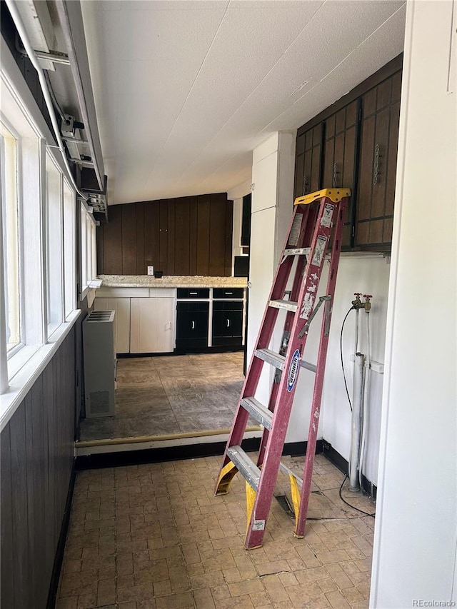 interior space featuring white cabinets and dark brown cabinetry