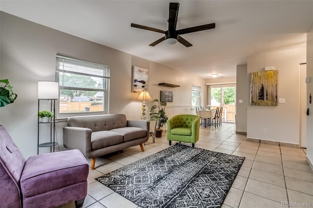999 Osceola St, Denver, CO 80204 - living area featuring light tile patterned floors, a ceiling fan, and baseboards