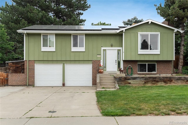 11805 W 74th Ave, Arvada, CO 80005 - raised ranch with an attached garage, roof mounted solar panels, concrete driveway, a front yard, and brick siding