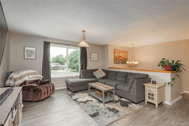11805 W 74th Ave, Arvada, CO 80005 - living room featuring light wood finished floors and a chandelier
