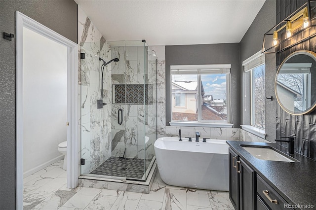full bath with marble finish floor, toilet, vanity, a marble finish shower, and a freestanding tub