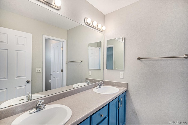 full bathroom with double vanity and a sink