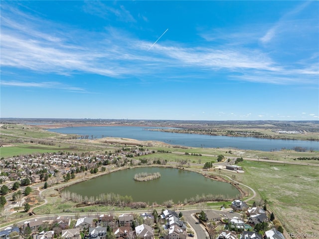 drone / aerial view featuring a water view and a residential view