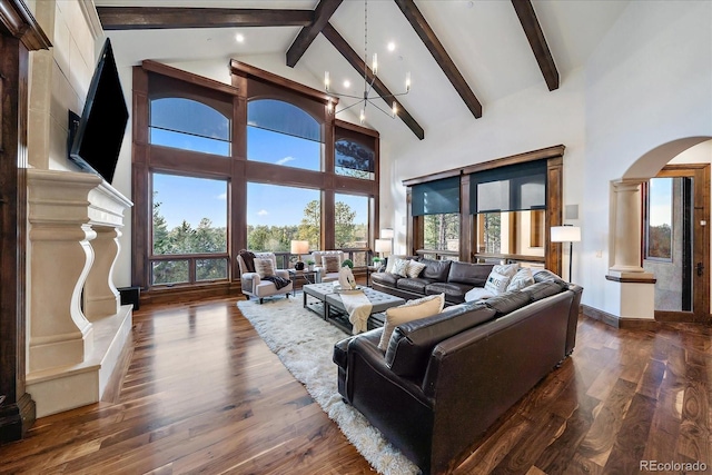 living room with dark hardwood / wood-style floors, beam ceiling, high vaulted ceiling, and a chandelier