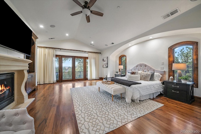 bedroom with ceiling fan, wood-type flooring, lofted ceiling, and access to outside