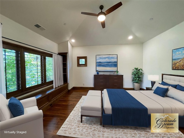 bedroom featuring ceiling fan, dark wood-type flooring, and vaulted ceiling