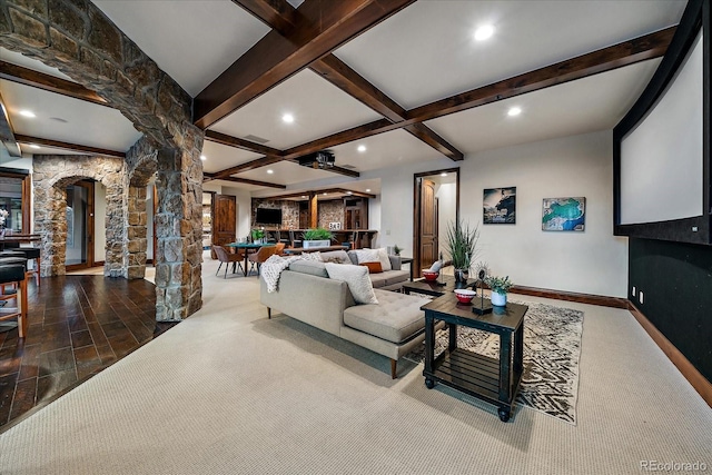 living room with beam ceiling and decorative columns