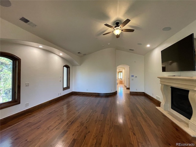 unfurnished living room with ceiling fan, dark hardwood / wood-style floors, and vaulted ceiling