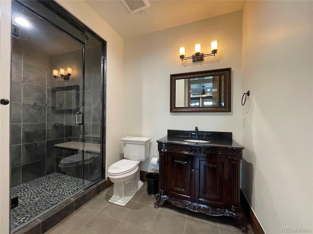 bathroom with an enclosed shower, vanity, ceiling fan, tile patterned flooring, and toilet