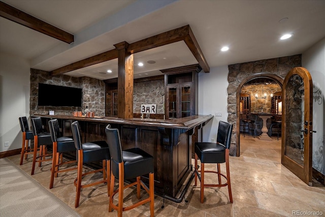 bar with beam ceiling and french doors