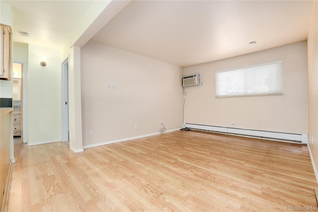empty room featuring baseboards, baseboard heating, an AC wall unit, and light wood-style flooring