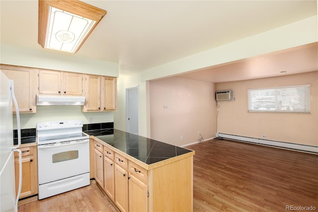 kitchen with under cabinet range hood, a peninsula, light brown cabinetry, and white appliances