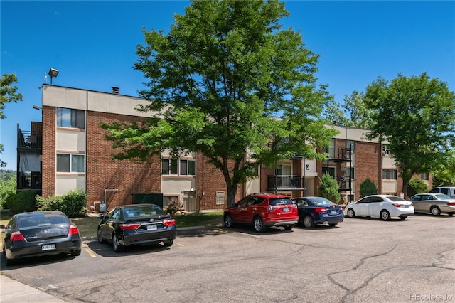 view of building exterior with uncovered parking