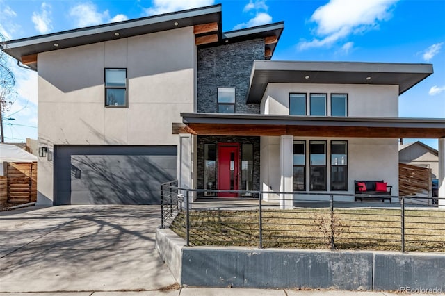 contemporary house with a porch and a garage