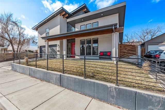 contemporary home with a garage and a porch