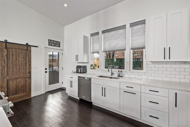 kitchen featuring sink, white cabinetry, tasteful backsplash, stainless steel dishwasher, and dark hardwood / wood-style flooring