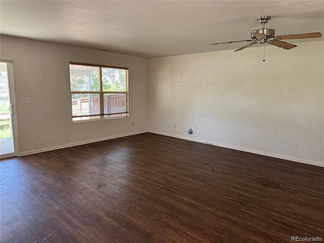 897 Mockingbird Ln, Brighton, CO 80601 - spare room featuring dark wood-type flooring, plenty of natural light, ceiling fan, and baseboards
