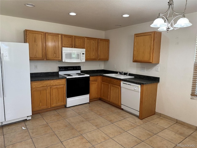 897 Mockingbird Ln, Brighton, CO 80601 - kitchen with white appliances, a sink, dark countertops, light tile patterned flooring, and recessed lighting